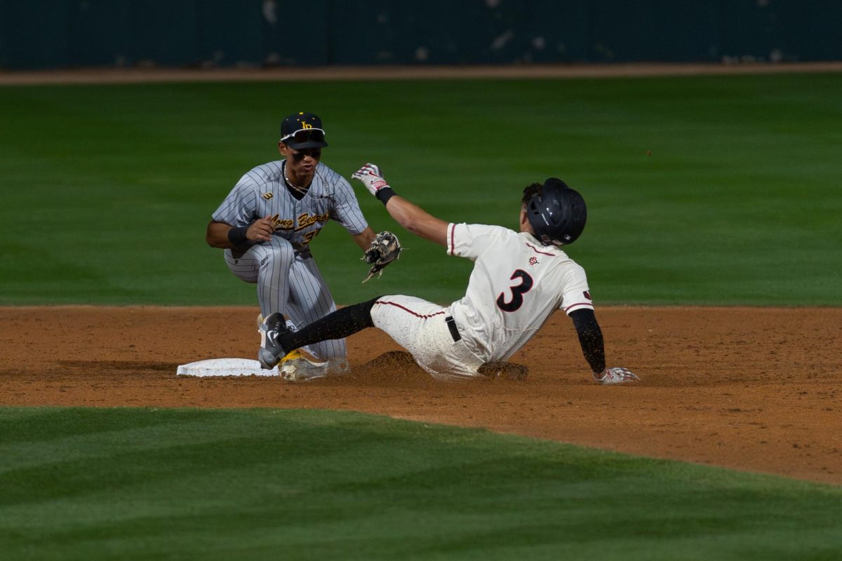 Outfielder Jake Jackson slides into plate against CSU Long Beach earlier this season at Tony Gwynn Stadium. Jackson batted in four runs, including a single double and triple in the 9-7 loss to the New Mexico Lobos on Sunday, April 28.