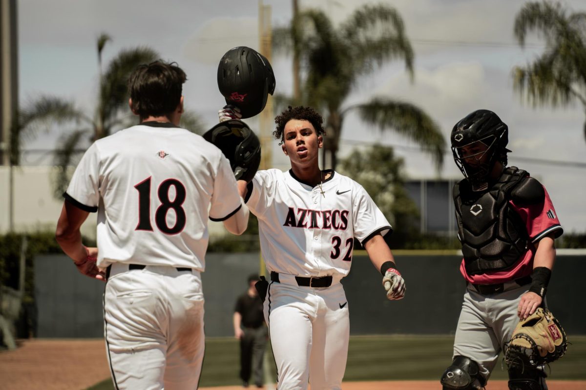 Infielder+Josh+Quezada+welcomes+teammate+and+outfielder+Josh+McCombs+to+the+plate.+McCombs+hit+his+fourth+home+runner+of+the+season+in+the+4-3+loss+to+UC+Irvine%2C+on+Friday%2C+April+19.+