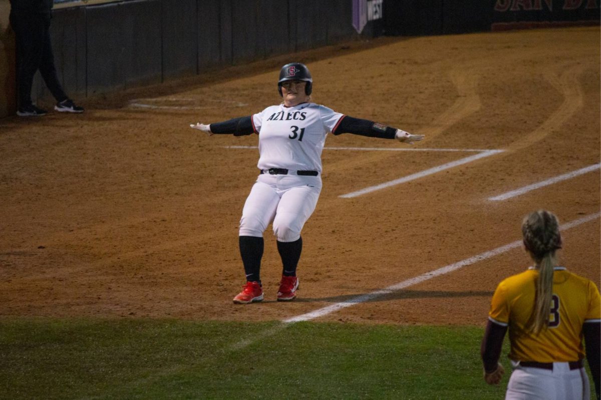 Utility Mac Barbara poses and makes a motion of being called safe earlier this season at SDSU Softball Stadium. Barbara paved the way for the Aztecs to sweep San Jose State with a 9-8 win on Sunday, April 14. 