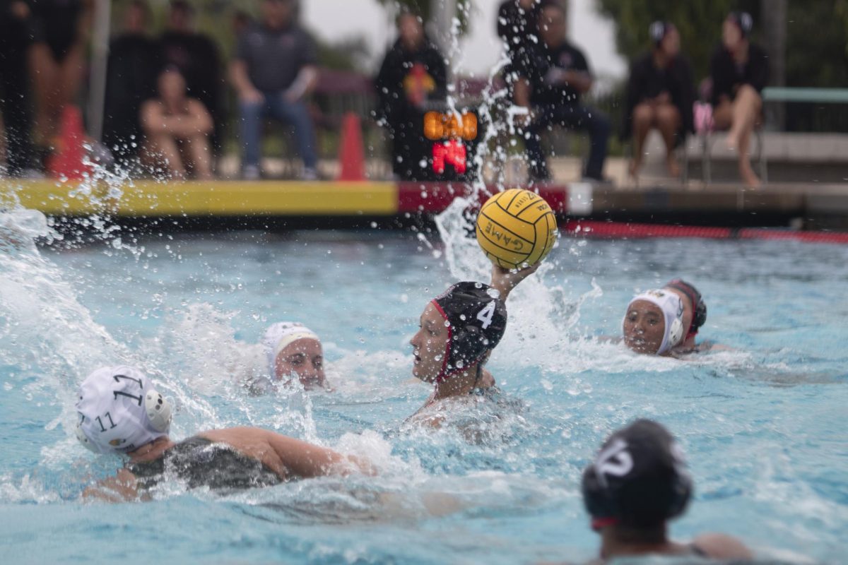 Attacker Kendall Houck looks through the defenders for a shot against Concordia at the Aztec Aquaplex on Friday, April 12. Houck helped the Aztecs defeat the Golden Eagles 12-8. 
