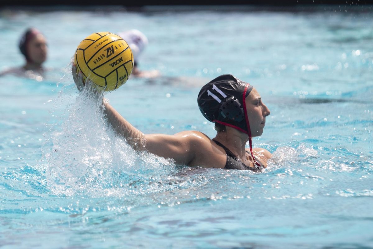 Attacker Claudia Valdes brings the ball out of the water to pass earlier this season at the Aztec Aquaplex. Valdes had a hat trick for the Aztecs in the 14-8 win over Santa Clara. 