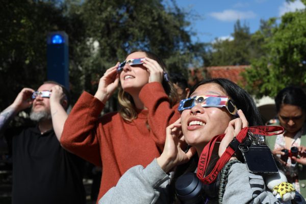 Students gaze up at the eclipse through protective eyewear provided by the SDSU Astronomy Department.