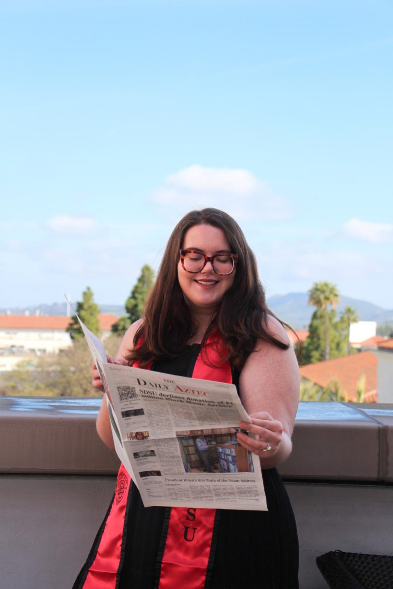 Eugenie Budnik holds a copy of The Daily Aztec outside of the Conrad Prebys Union on March 27, 2024.