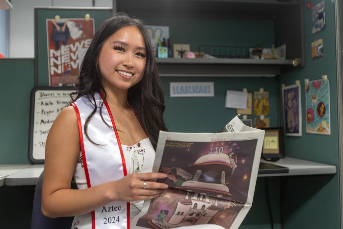 Hannah Ly holds an issue of The Daily Aztec in her office on May 1, 2024