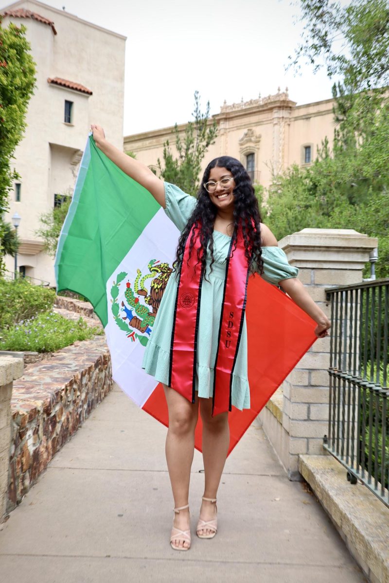 Jennifer Aguilar holds a Mexican flag at Balboa Park in San Diego on April 12, 2024.