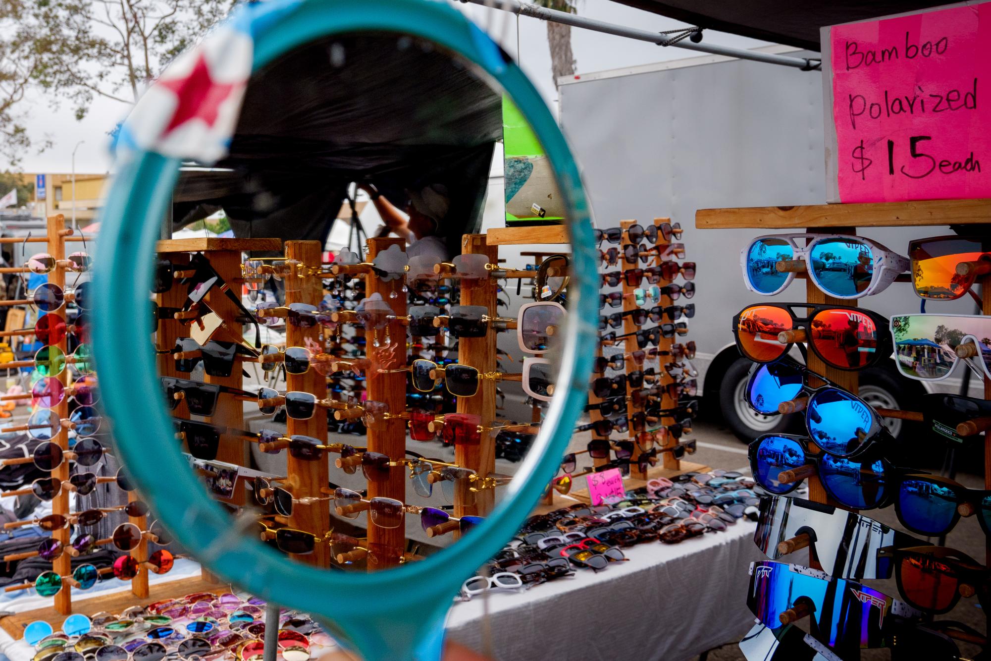 A stall at a market displaying a variety of sunglasses for sale on July 12, 2024.