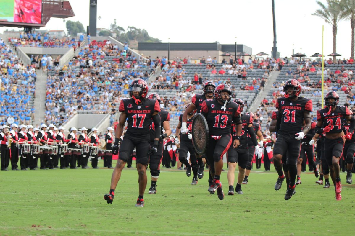 San Diego State Aztecs players run out on to the field before the game against the UCLA Bruins at Snapdragon Stadium. Sep. 9, 2023.

