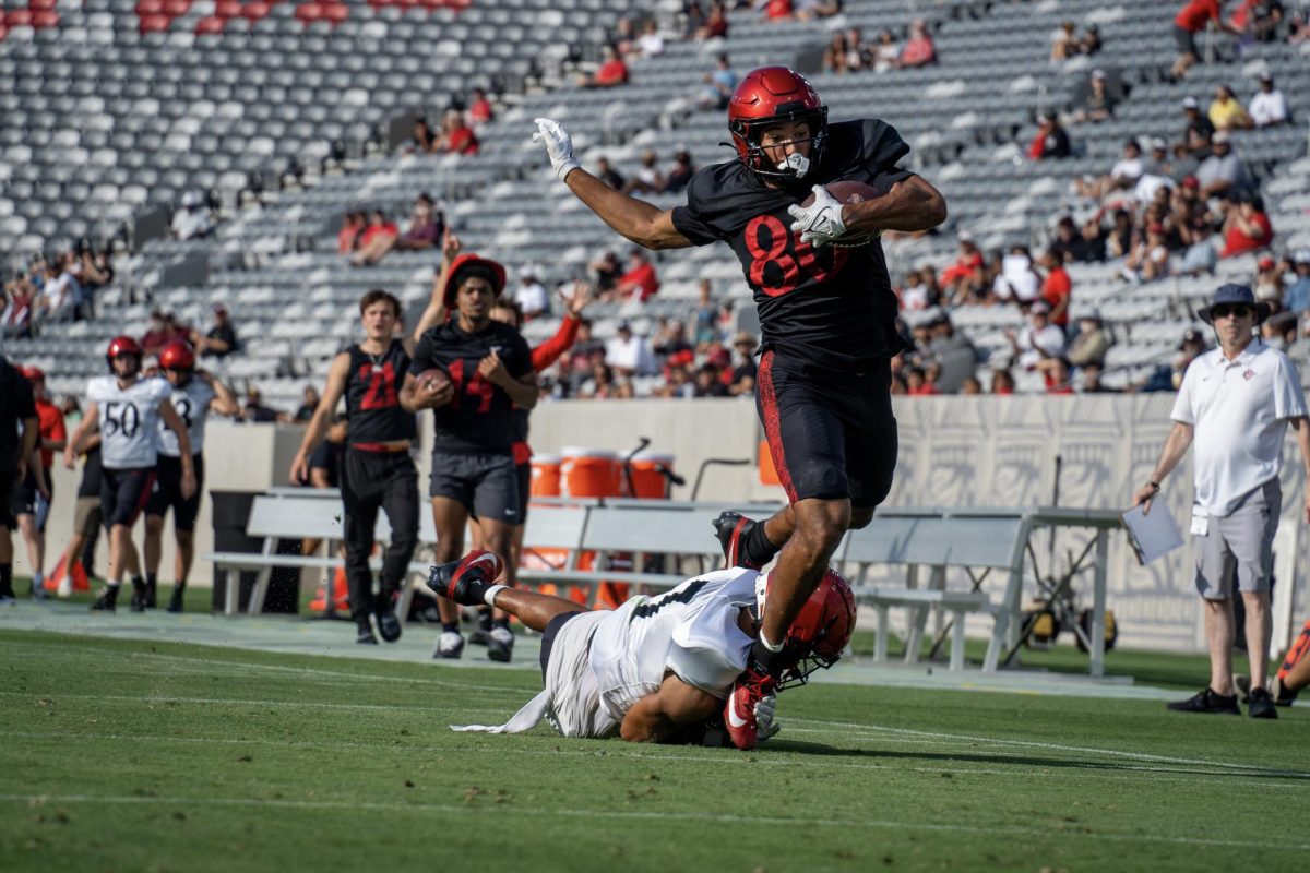 San Diego State wide receiver Baylin Brooks gets tripped up down the left sideline of the field by safety William Nimmo Jr. on Saturday, Aug. 10 at SnapDragon Stadium. 