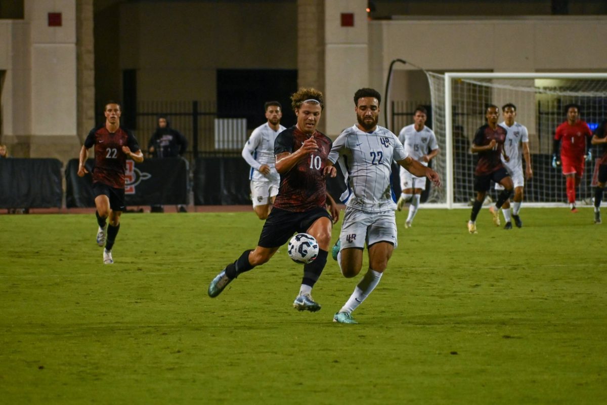 Forward Austin Brummett runs neck and neck with his opponent to get the ball down the field against UC Riverside at SDSU Sports Deck on Friday, Aug 23. Brummett had two goals to help the Aztecs defeat the Highlanders 5-2. 