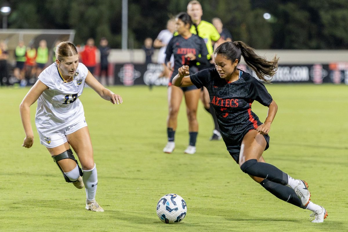 San Diego State forward Emma Gaines-Ramos tries to dribble past University of California, San Diego defender Leilah Raad on Thursday, Sept.12 at SDSU Sports Deck.