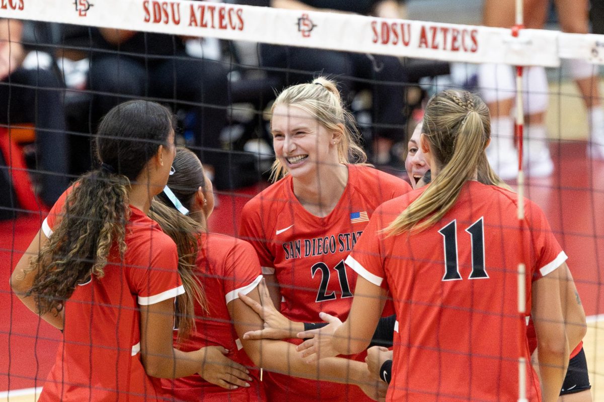 San Diego State middle blocker Kat Cooper smiles at her teammates after winning a point on Thursday, Sept. 5 at the Aztec Court inside Peterson's Gym. 