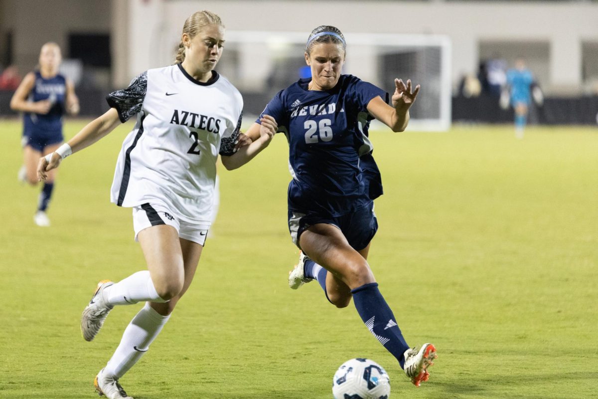 San Diego State forward Mia Lane, left, battles for possession of the ball against Nevada defender Abigail Souza at the SDSU Sports Deck on Thursday, Sept. 26.