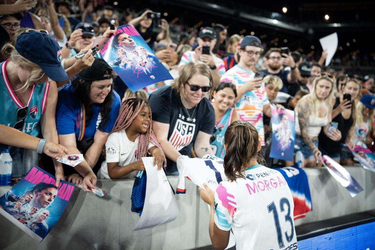 San Diego Wave forward Alex Morgan goes to the front row of SnapDragon Stadium to greet fans and sign autographs for adoring fans. 