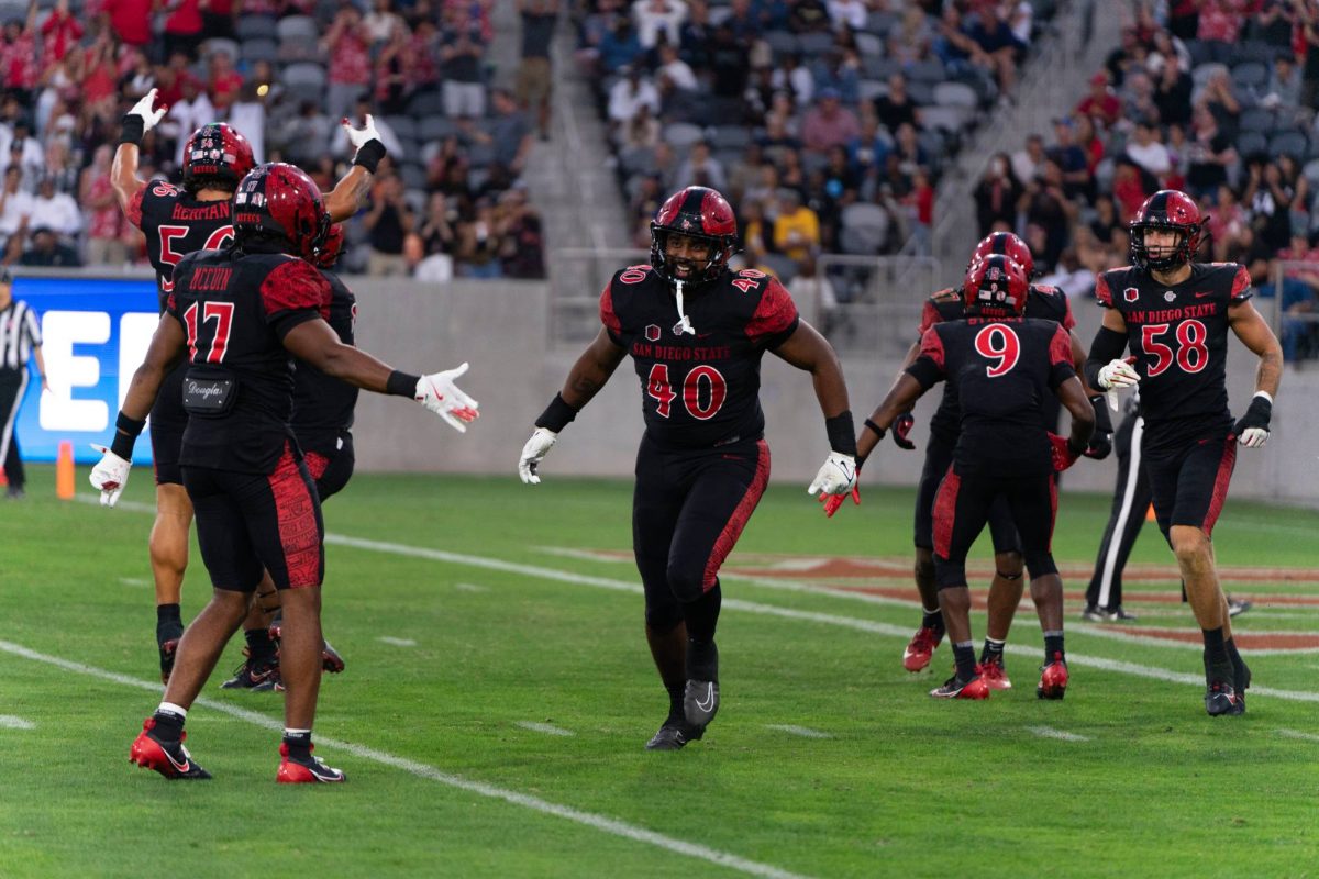 Aztec defensive lineman Krishna Clay celebrates with his teammates during the home opener against the Texas A&M Commerce Lions at Snapdragon stadium Aug. 31, 2024