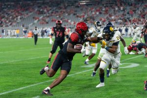 San Diego State wide receiver Jordan Napier holds off a Lions defender at Snapdragon Stadium earlier this season. Napier had two receptions, 53 yards and the lone touchdown in the 31-10 loss against the Golden Bears. 