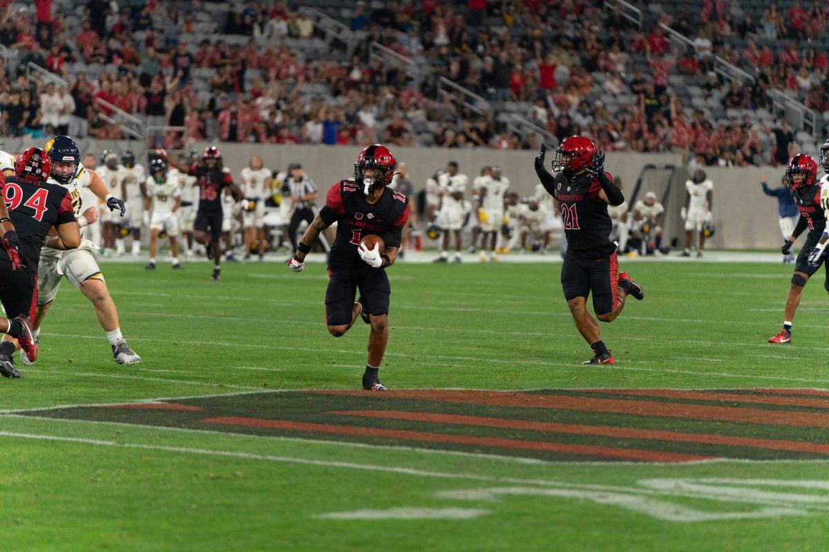 San Diego State safety JD Coffey III intercepts a pass against Texas A&M - Commerce before taking it back to the end zone for a pick six at SnapDragon Stadium. 