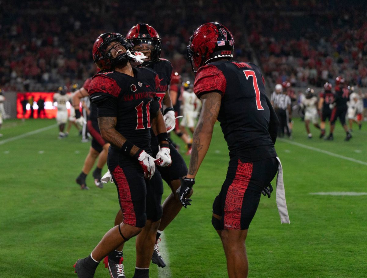 San Diego State safety JD Coffey III celebrates his pick-six with teammate safety William Nimmo Jr. at Snapdragon Stadium on Saturday, Aug. 31. Coffey III had a 45-yard return for a touchdown off the interception to help the Aztecs defeat the Lions 45-14.