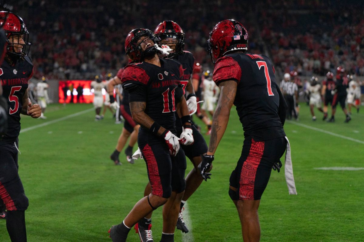 San Diego State safety JD Coffey III celebrates his pick-six with teammate safety William Nimmo Jr. at Snapdragon Stadium on Saturday, Aug. 31. Coffey III had a 45-yard return for a touchdown off the interception to help the Aztecs defeat the Lions 45-14.
