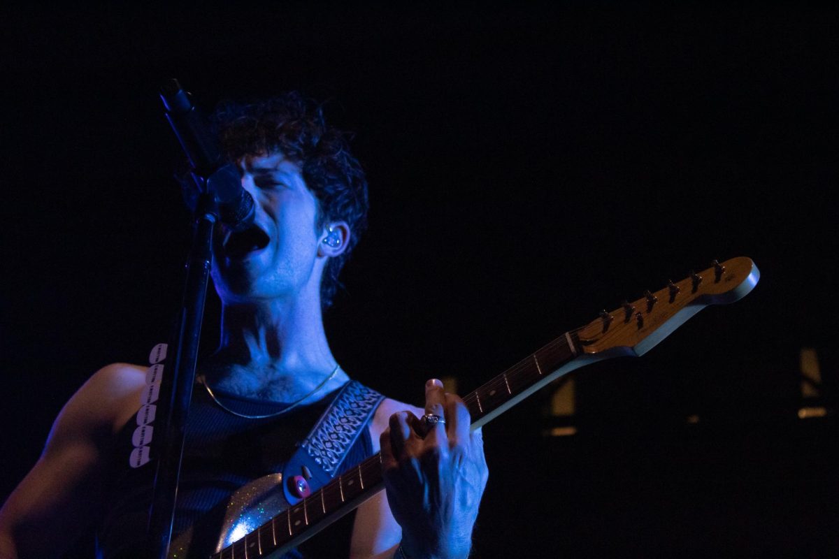 Dylan Minnette, lead singer of Wallows, sings into the mic while playing guitar at the Cal Coast Credit Union Open Air Theater, at SDSU on Tuesday, Sept. 10, 2024.