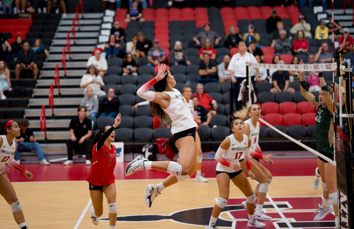 Middle blocker Talea Mitchell kills it on the court with a hit set up by setter Andrea Campos at their game against Colorado State University on October 17, 2024.