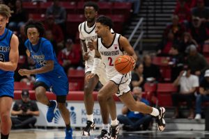 San Diego State guard Nick Boyd dribbles up the court with teammates surrounding him at Viejas Arena. 