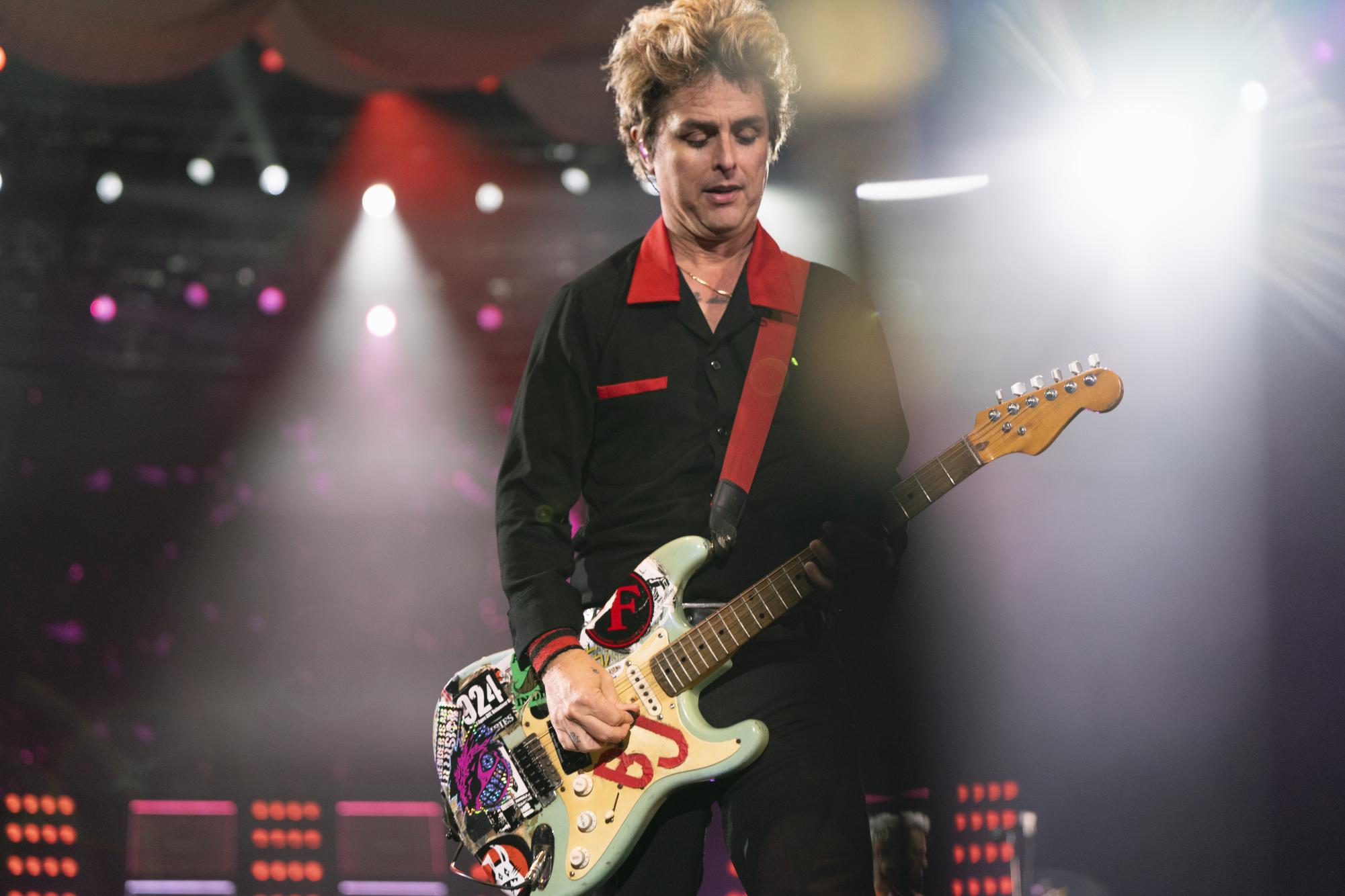 Billie Joe Armstrong focuses on his guitar solo at the edge of the stage at Petco Park on Sept. 28, 2024.