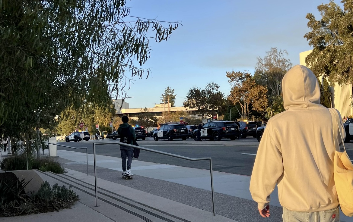 SDSU students walk toward campus as police search the area for suspects 