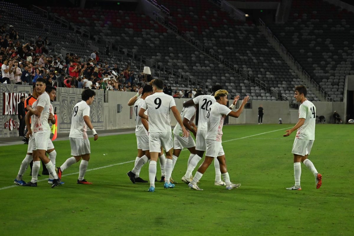 SDSU men's soccer team celebrates after senior forward Terence Okoeguale scores a goal against UC Davis at Snapdragon Stadium on Sept. 21, 2024