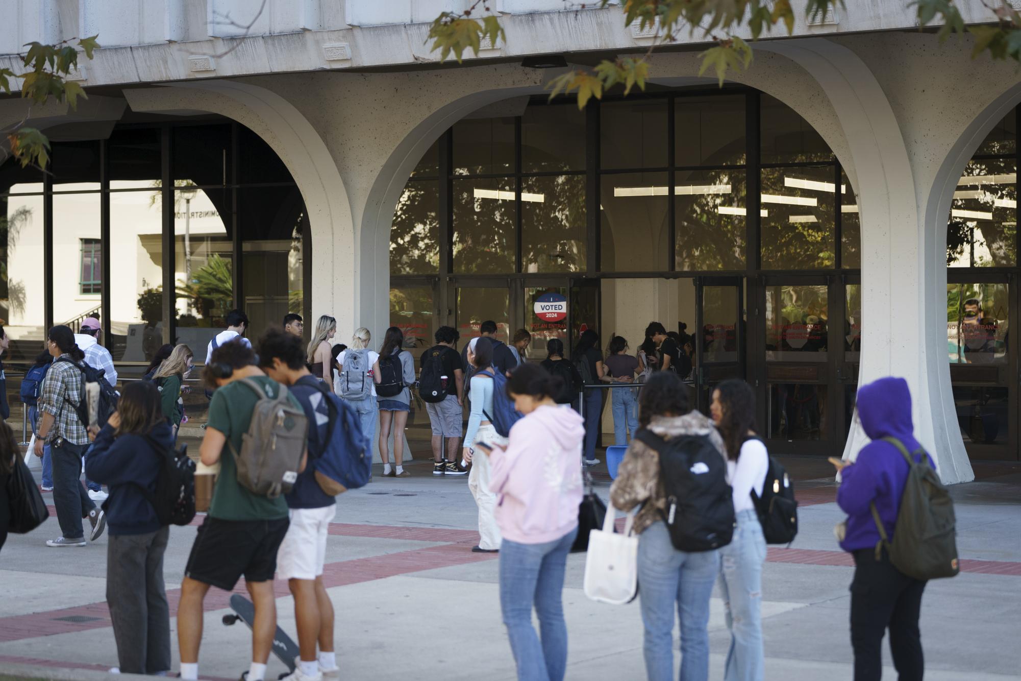 The line to vote at the Love Library voting center snakes out of the doors on Nov. 5, 2024.