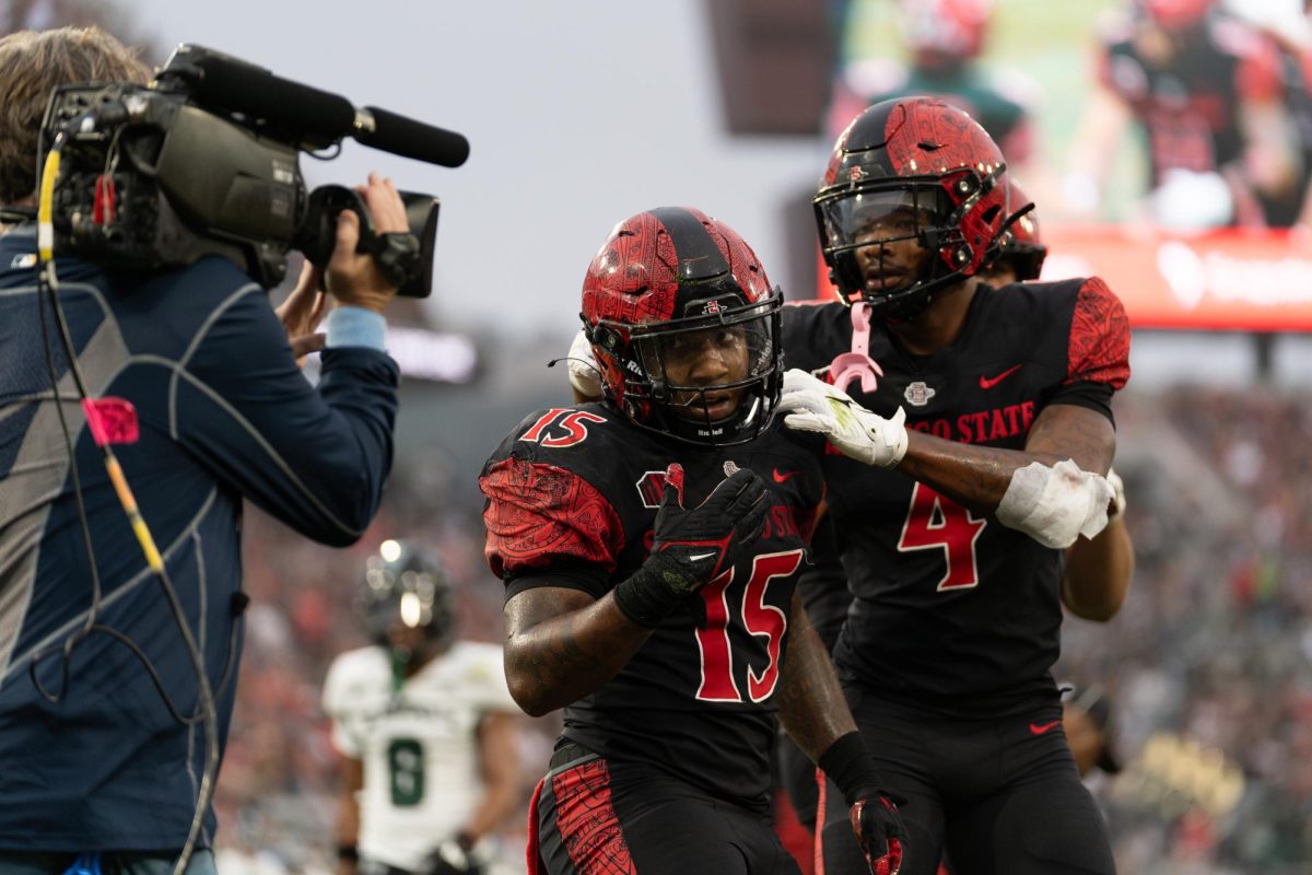 San Diego State senior running back Marquez Cooper (left) celebrating his touchdown with junior wide receiver Louis Brown IV (right) earlier this season at Snapdragon Stadium. 