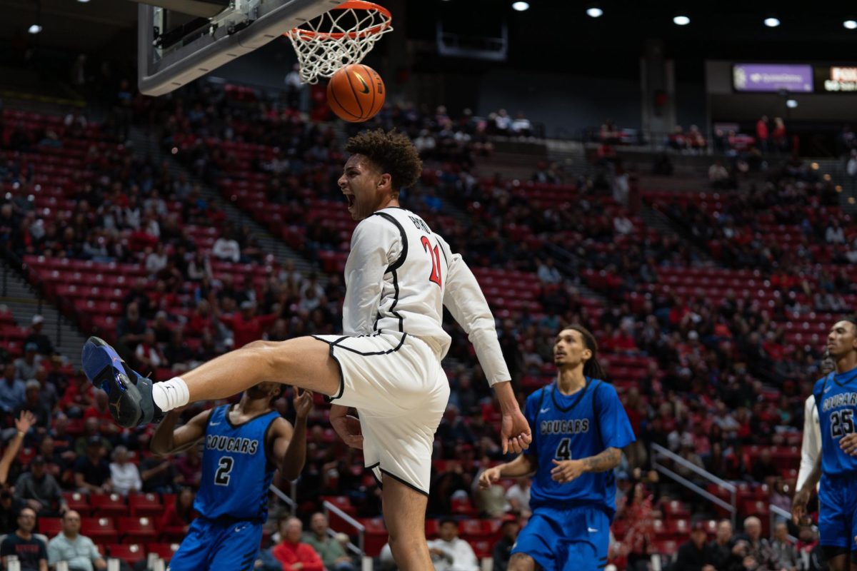 Sophomore guard Miles Byrd energized after a dunk against Cal State San Marcos on Oct. 30, 2024 at Viejas Arena. 