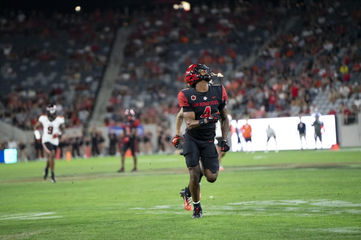 San Diego State wide receiver Louis Brown IV attempts to locate the ball on a deep route earlier this season at SnapDragon Stadium. 