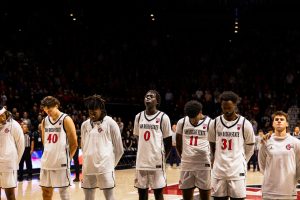 The San Diego State men's basketball team line up together for the national anthem at Viejas Arena. 