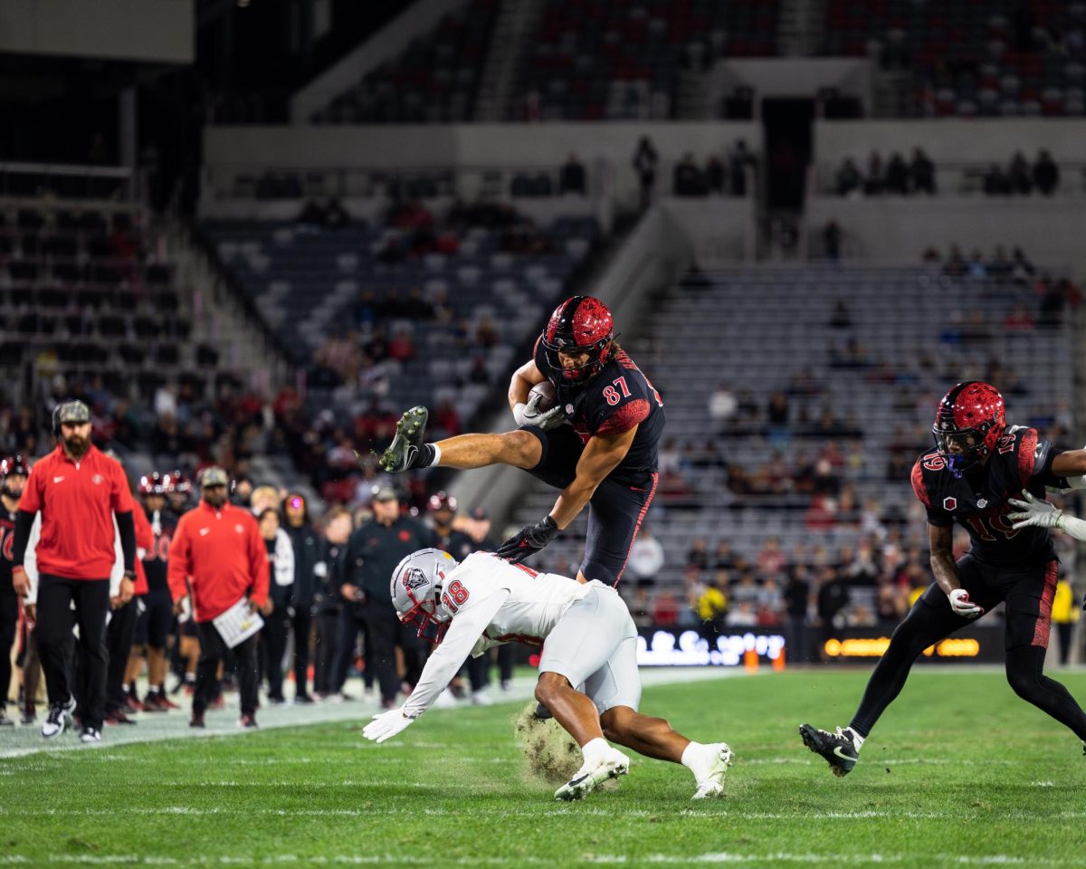 SDSU senior tight end Michael Harrison hurdles a defender during their Nov. 9 contest against the University of New Mexico in Snapdragon stadium