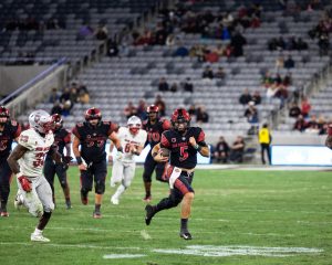 San Diego State quarterback Danny O' Neil looks up-field as he runs from defenders for positive gain earlier this season at SnapDragon Stadium. O' Neil had 162 passing yards, two passing touchdowns, two interceptions, and one rushing touchdown in the 41-20 loss to UNLV. 
