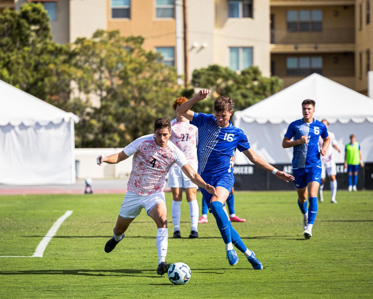 SDSU defender André Puente evades defender