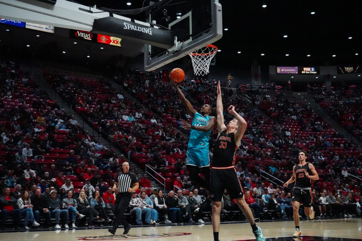 San Diego State guard BJ Davis lays the ball up against the taller defender during the Aztecs win over Occidental Tuesday, Nov. 12 at Viejas Arena