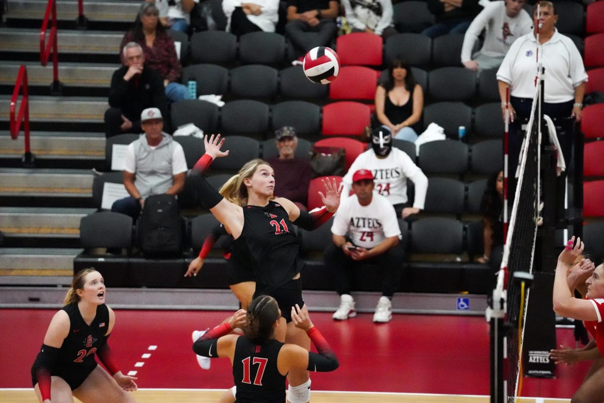 San Diego State middle Blocker Kat Cooper attacks the ball against New Mexico on Thursday, Nov. 21 at Aztec Court at Peterson Gym.