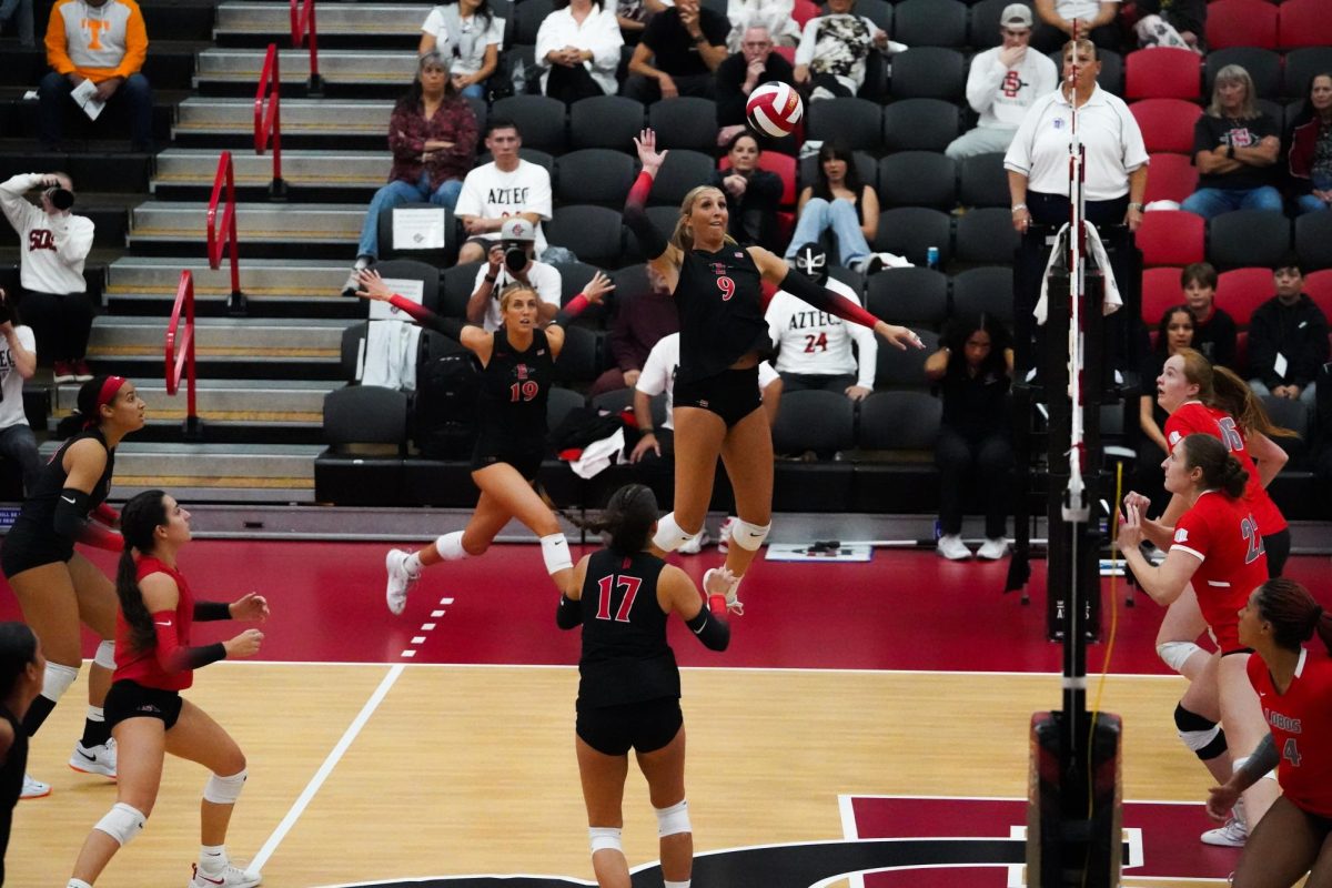 San Diego State middle Blocker Shea Rubright elevates to attack the ball against New Mexico on Thursday, Nov. 21 at Aztec Court at Peterson Gym.