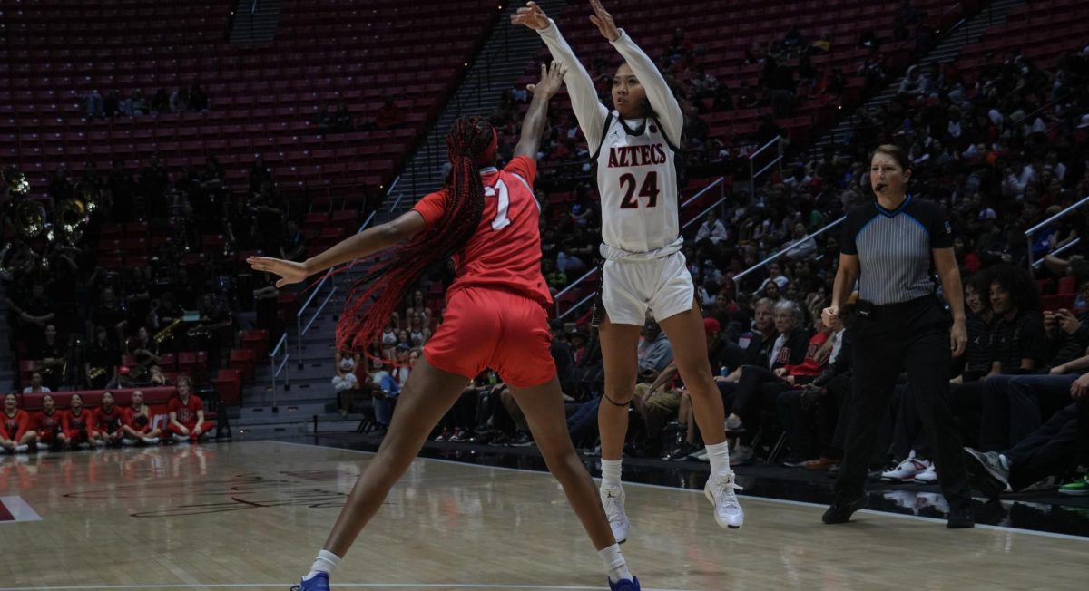 San Diego State freshman guard Naomi Panganiban puts up a three point shot over Bethesda guard Jacqueline Aguilar in a 107-36 win on Friday, Dec. 6 at Viejas Arena. 