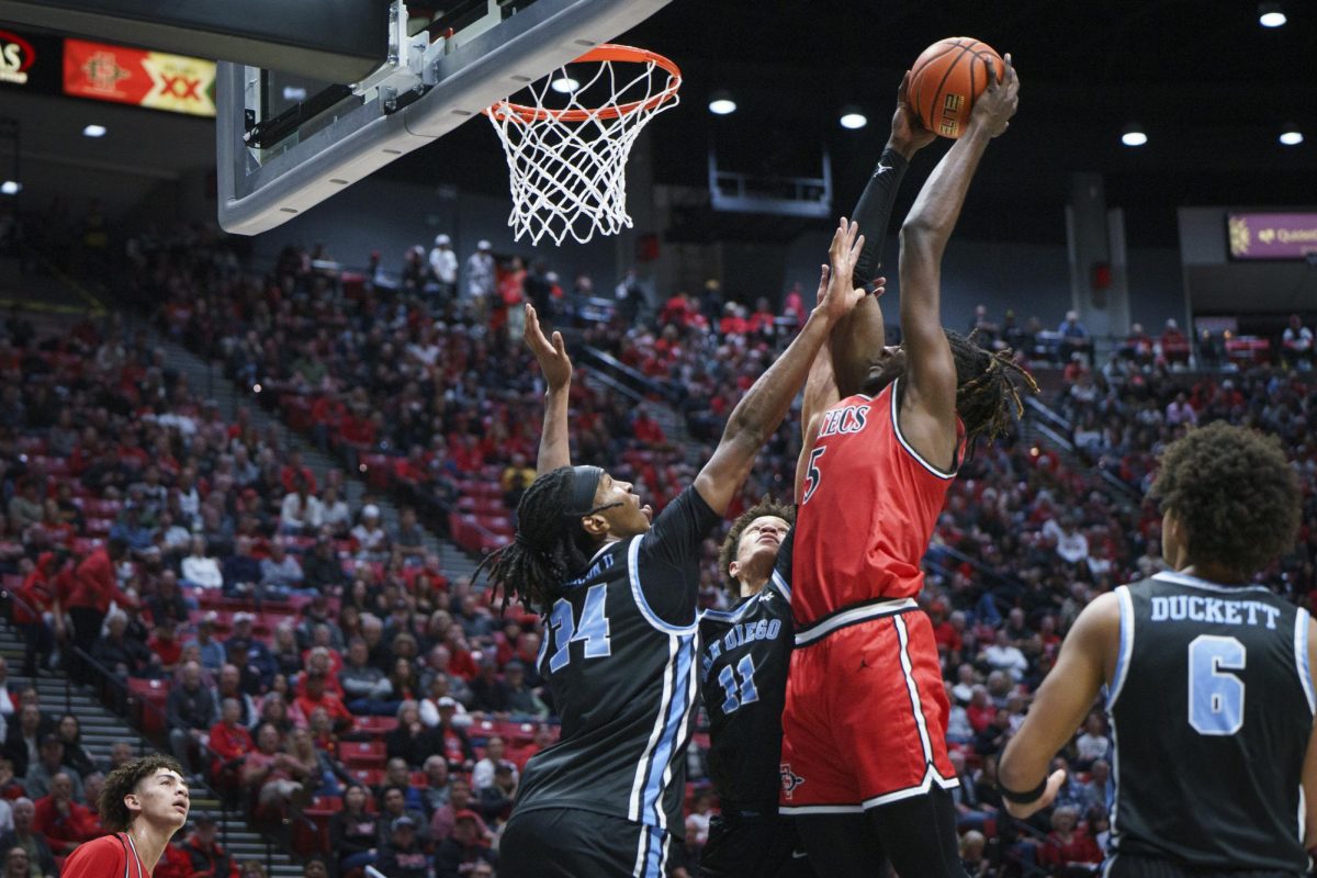 San Diego State forward Pharaoh Compton stretches past the USD defense at Viejas Arena on Dec. 7, 2024. 