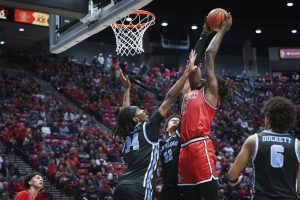 San Diego State forward Pharaoh Compton stretches past the USD defense at Viejas Arena on Dec. 7, 2024. 