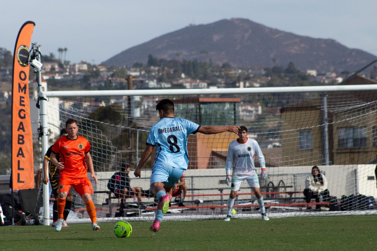 Number 8 on blue taking a shot on goal against Orange in the Omegaball tournament on Friday, December 13 at the SDSU Sports Deck 