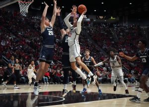 Guard Miles Byrd takes up a strong shot against the defense against Utah State on December 28, 2024 at Viejas Arena.