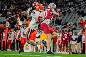 Both players make a play on the ball during the Holiday Bowl matchup between Syracuse and Washington State at Snapdragon Stadium