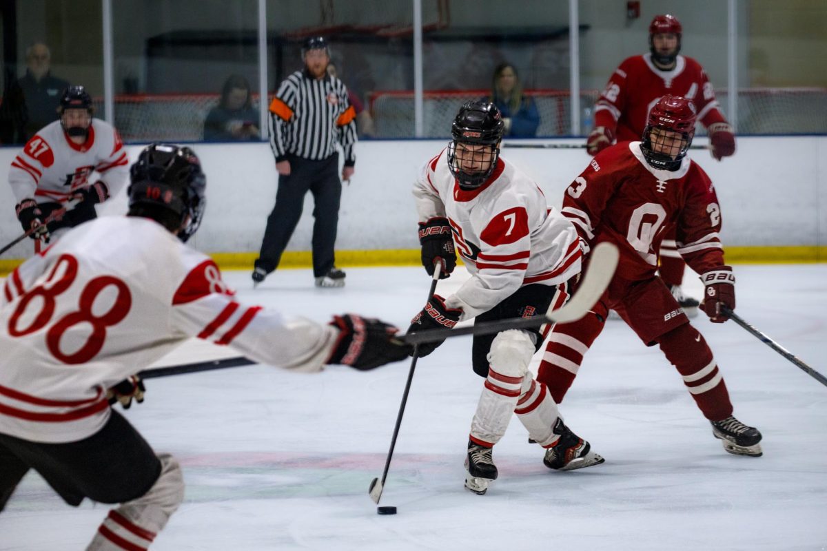 San Diego State forwardMason Brown, handles the puck while weaving through defenders at Kroc Center Ice Arena on January 17, 2025. 