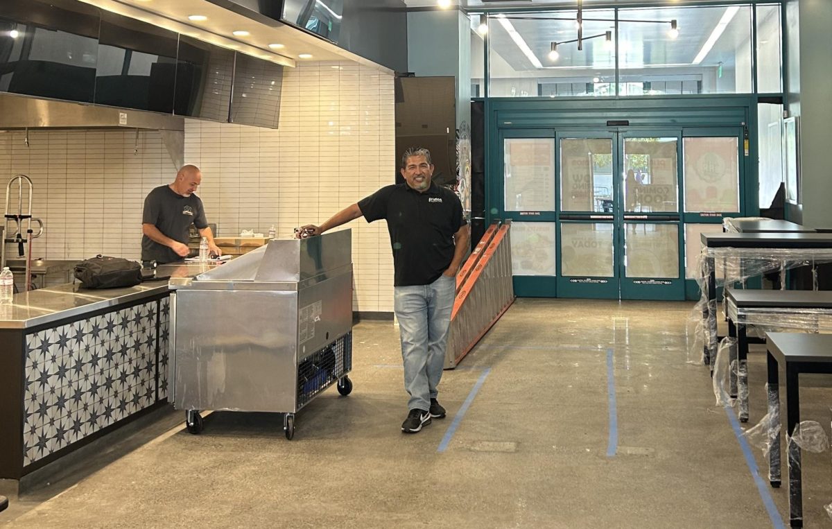 Restaurant owner Felix Calero, middle, inside Primos at SDSU before its opening.