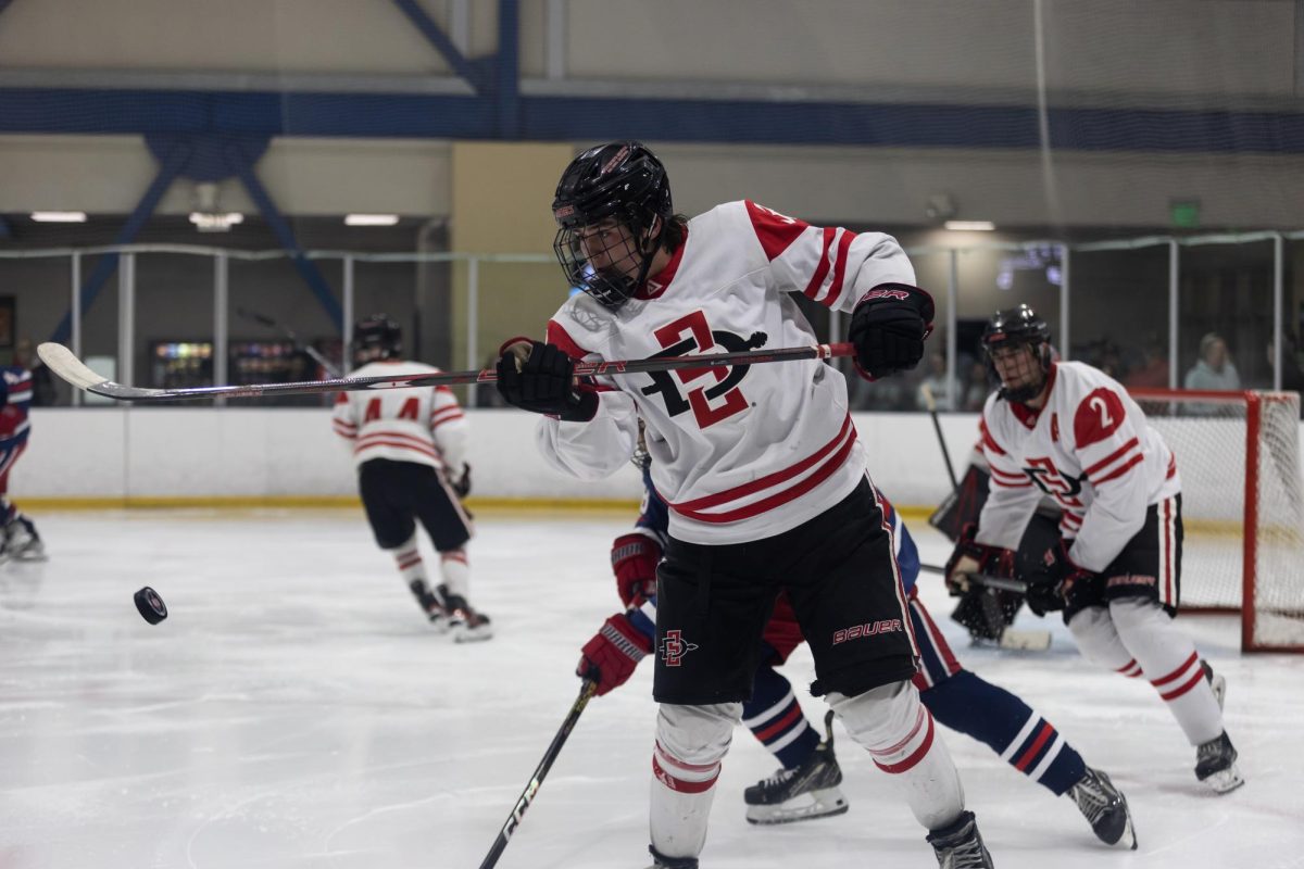 San Diego State defenseman Connor Hennigan (#33) battles for control of the puck in front of the net during a game against the University of Arizona at Kroc Ice Arena on Feb. 7.