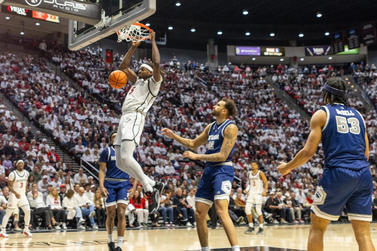 San Diego State forward Pharaoh Compton (5) catches the ball in the paint and turns around for a quick dunk against Nevada on Saturday, March 8, 2025, at Viejas Arena in San Diego.