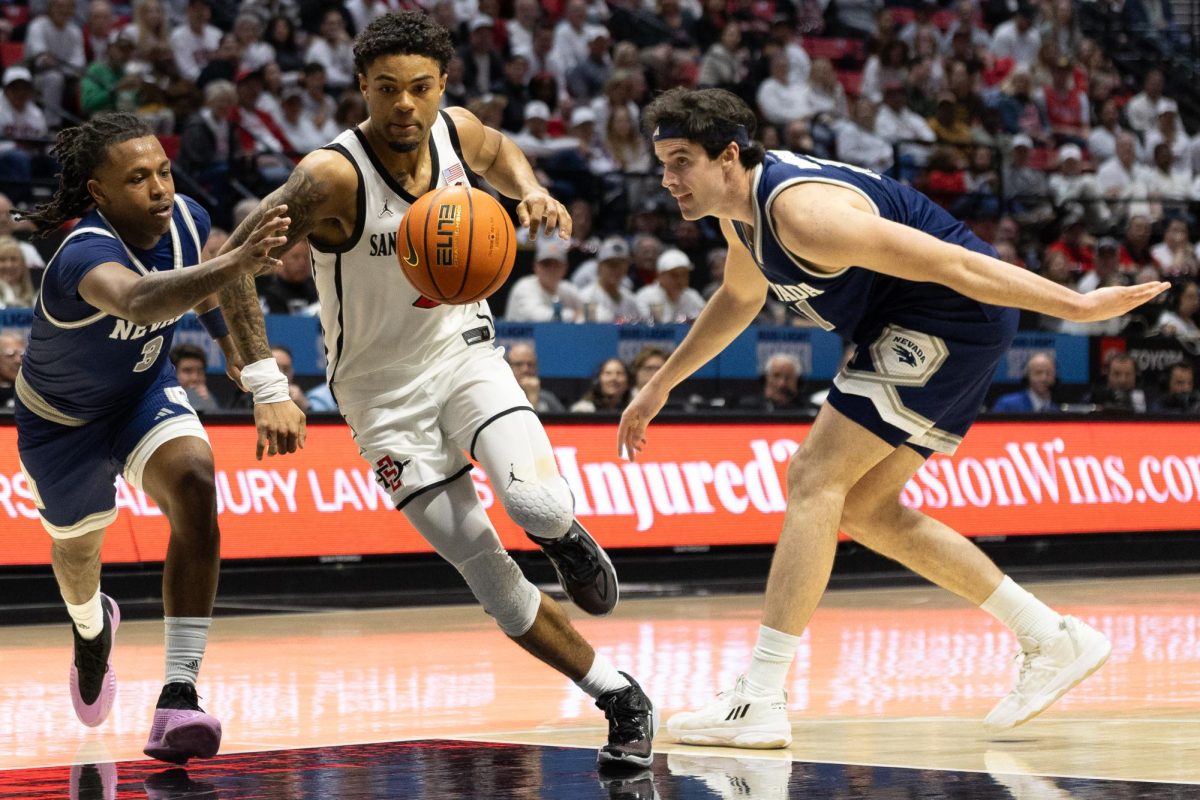 San Diego State guard Nick Boyd (2), middle, drives through the Nevada defense into the paint for a layup on Saturday, March 8, 2025, at the Viejas Arena in San Diego.